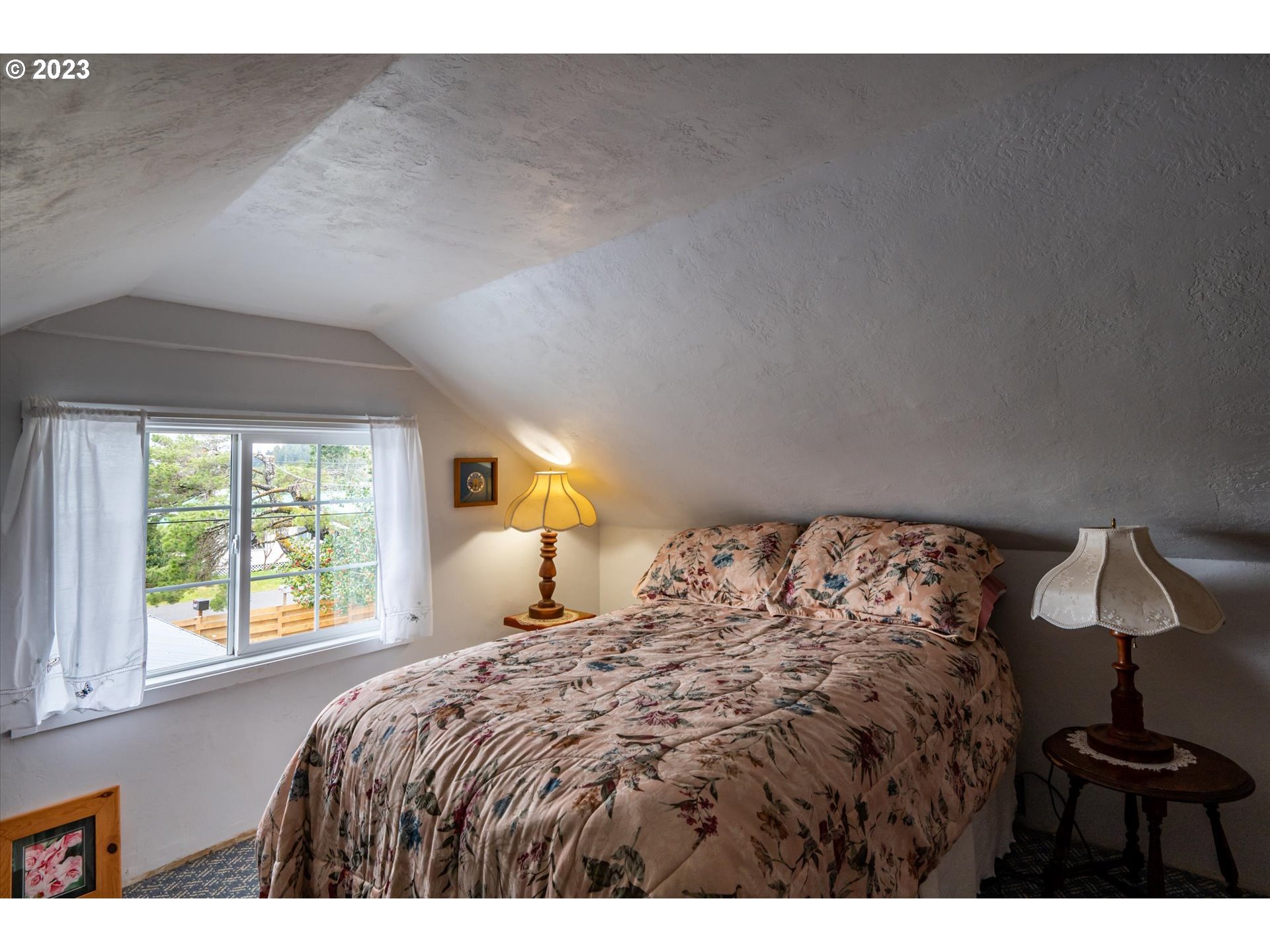 100 South 6th Street Lakeside, OR 97449 - Photo 15 of 42 a bedroom with a bed and a window