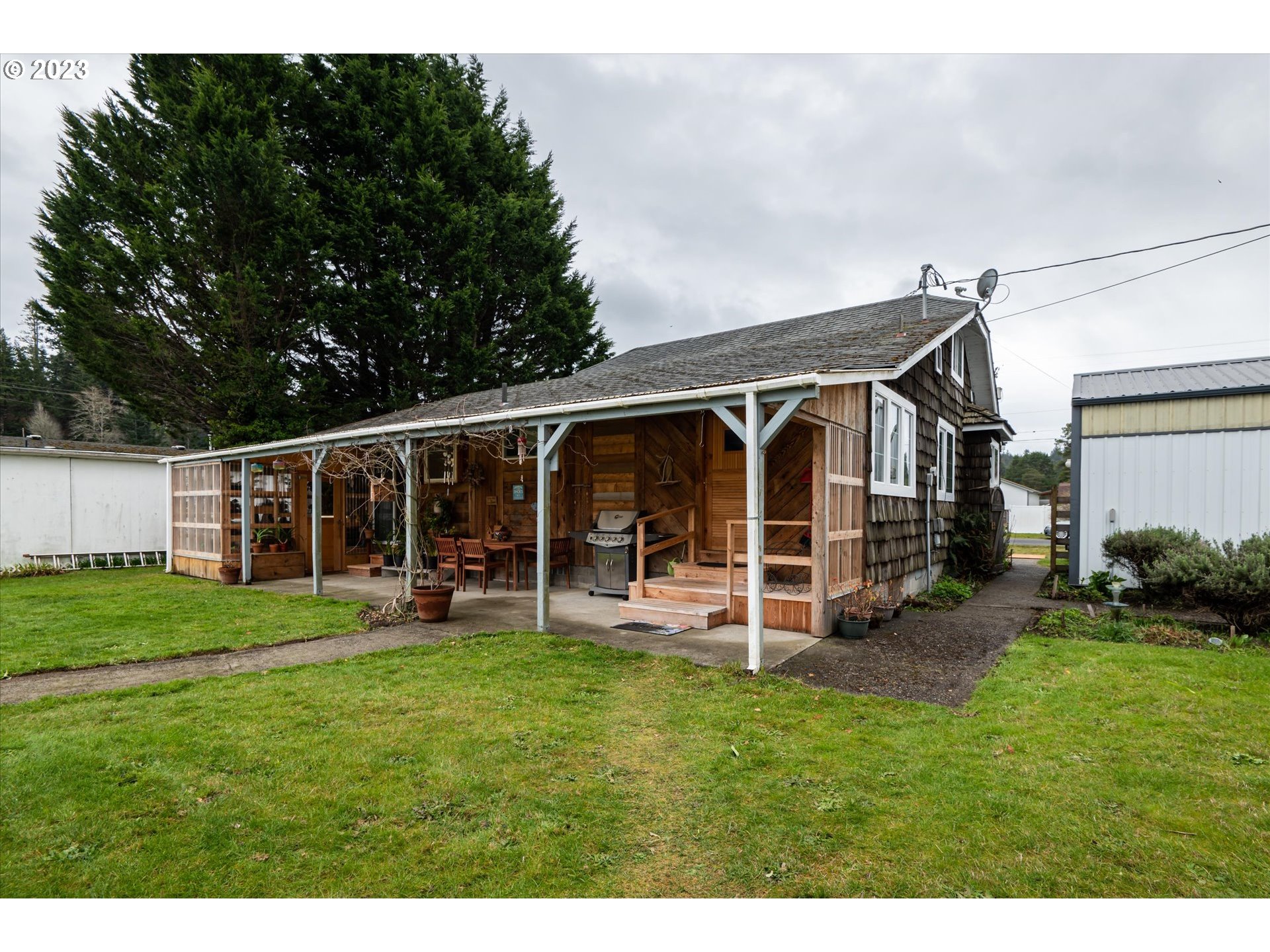 100 South 6th Street Lakeside, OR 97449 - Photo 18 of 42 a view of a house with a yard and sitting area