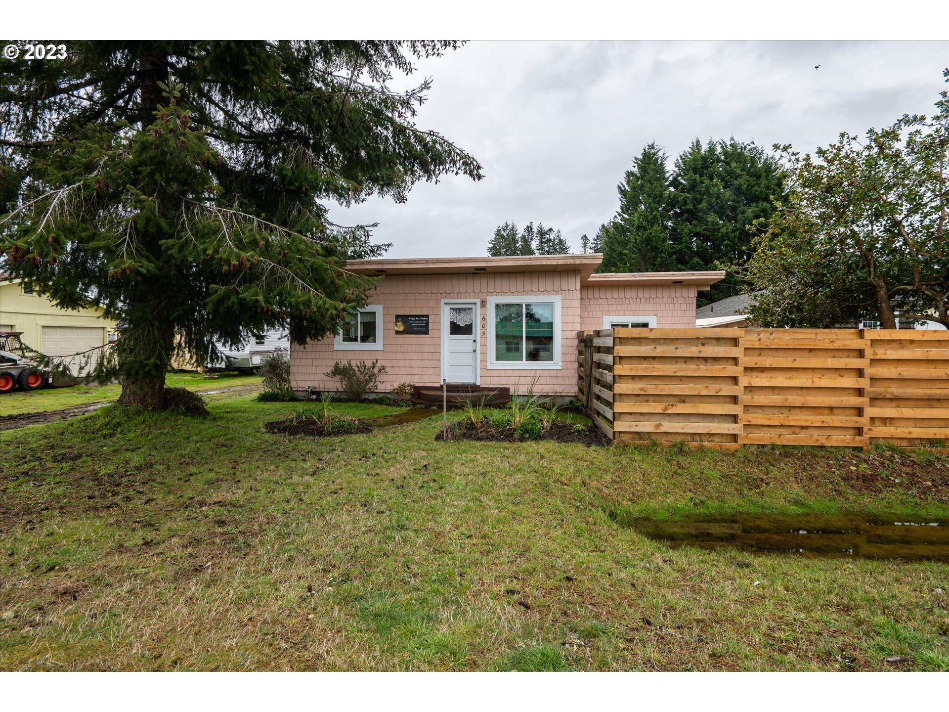100 South 6th Street Lakeside, OR 97449 - Photo 24 of 42 a backyard of a house with a garden and outdoor seating