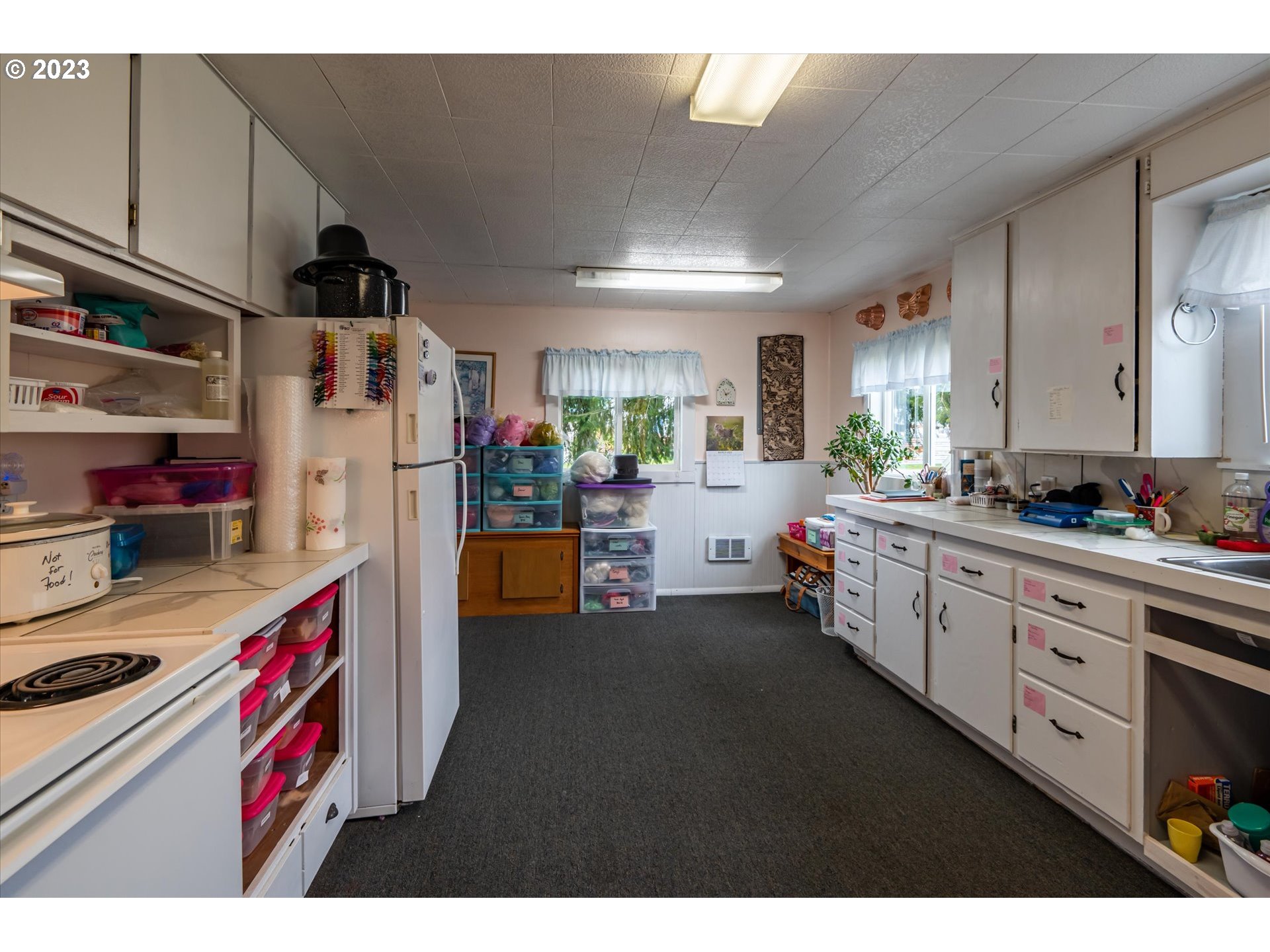 100 South 6th Street Lakeside, OR 97449 - Photo 26 of 42 a kitchen that has a lot of cabinets a washer and dryer