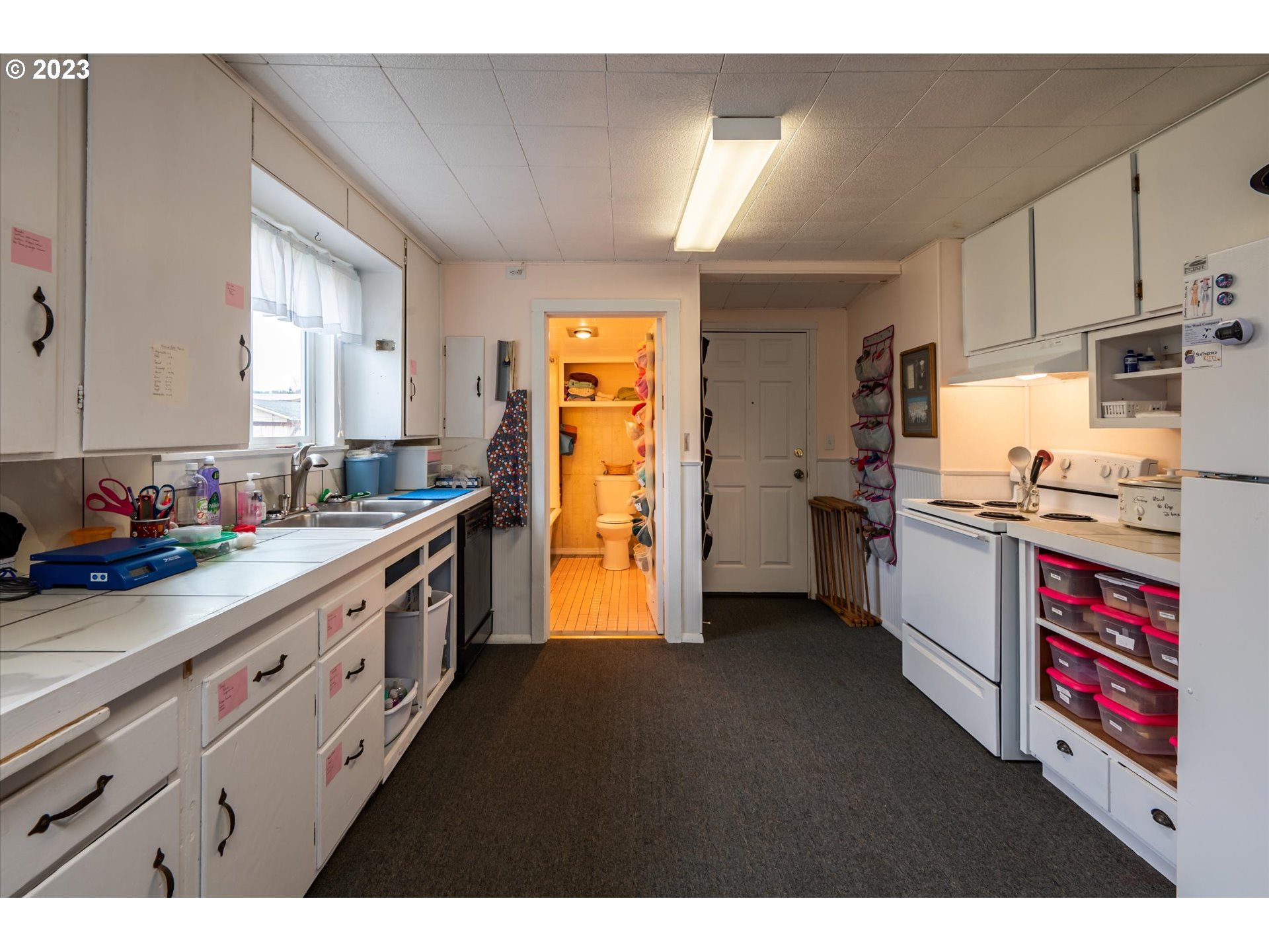 100 South 6th Street Lakeside, OR 97449 - Photo 27 of 42 a kitchen with stainless steel appliances a sink and a refrigerator