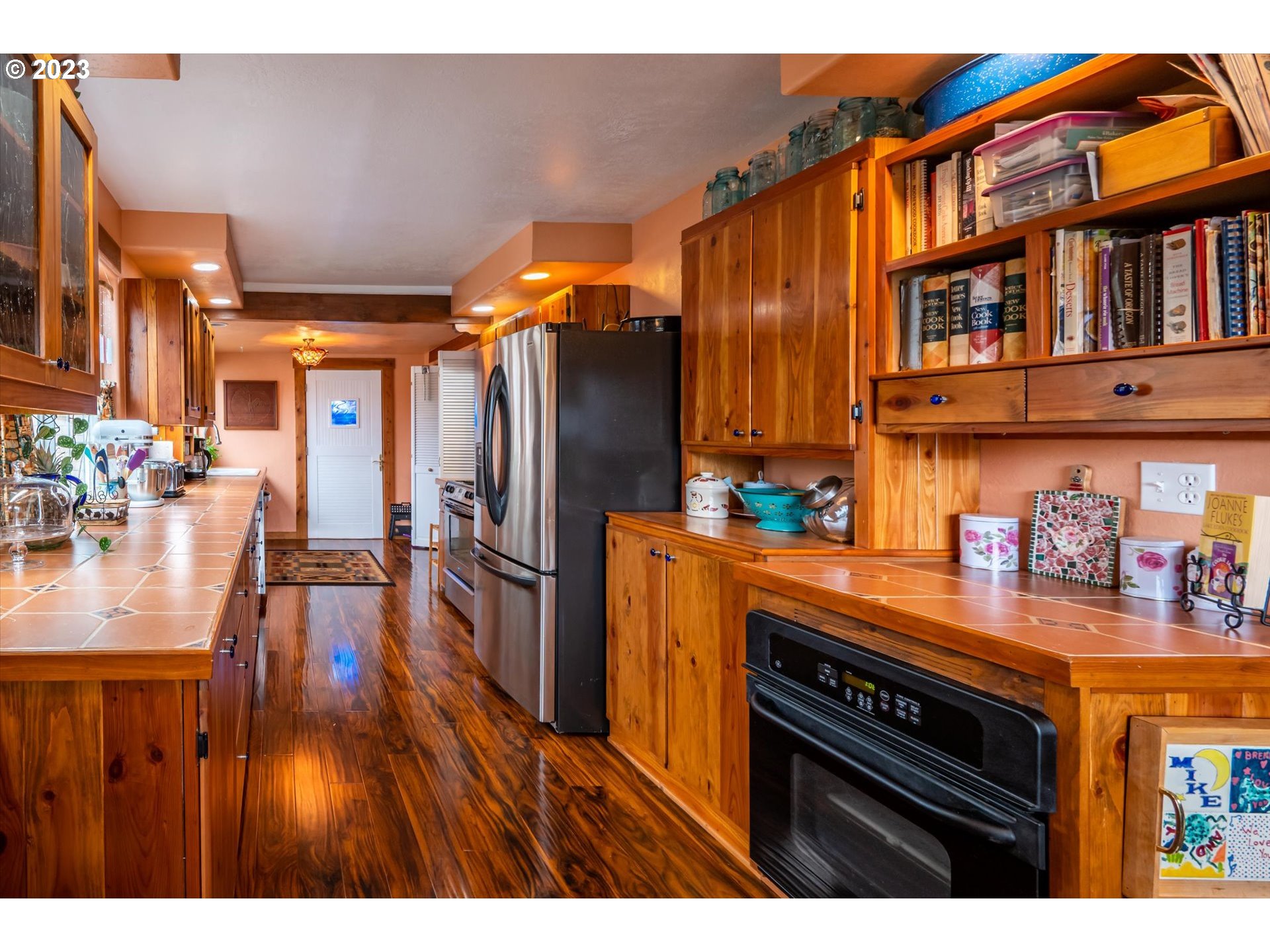 100 South 6th Street Lakeside, OR 97449 - Photo 4 of 42 a kitchen view of a kitchen island wooden floor and stainless steel appliances