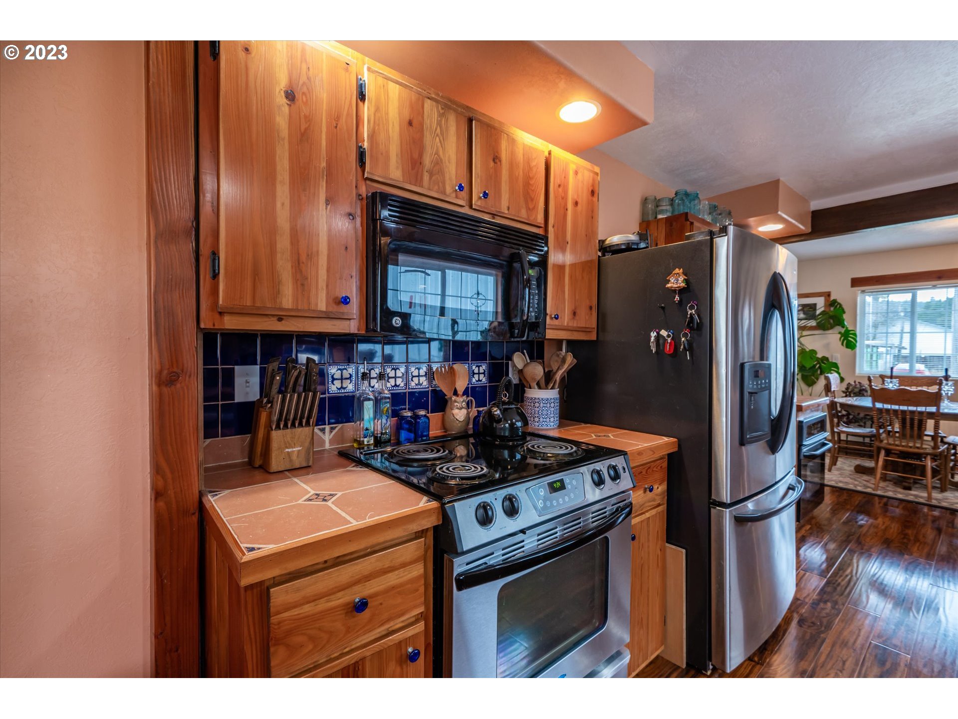 100 South 6th Street Lakeside, OR 97449 - Photo 6 of 42 a kitchen with stainless steel appliances granite countertop a stove refrigerator and a microwave
