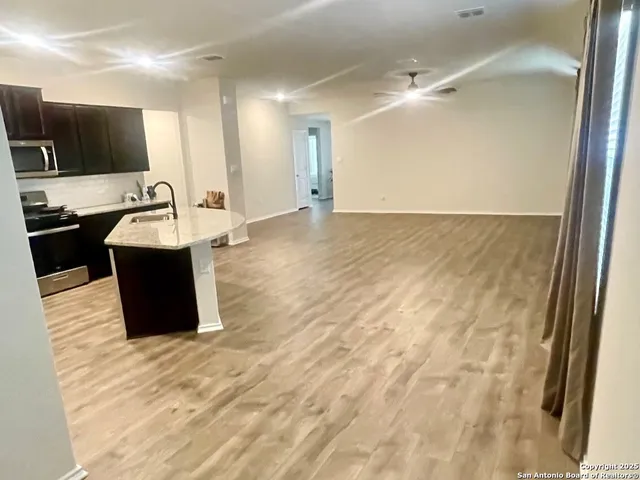 a view of a kitchen with a sink and a refrigerator