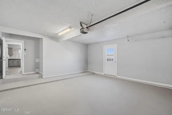 a spacious bathroom with a shower a sink and a mirror