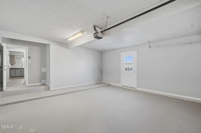 a spacious bathroom with a shower a sink and a mirror