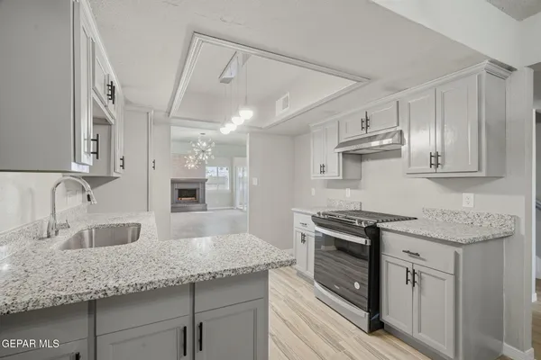 a spacious bathroom with a granite countertop sink a toilet a mirror and shower