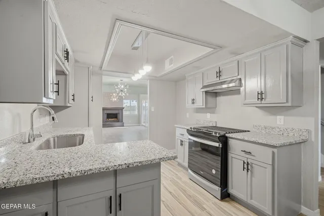 a spacious bathroom with a granite countertop sink a toilet a mirror and shower