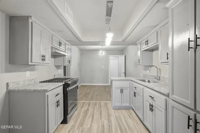 a spacious bathroom with a granite countertop sink a toilet a mirror and shower