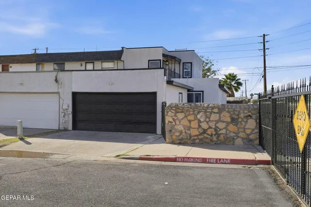 a view of a house with a balcony and garage