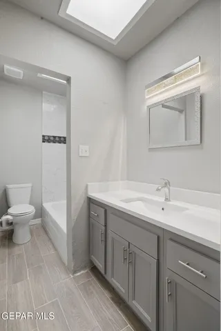 a white toilet sitting next to a bath tub