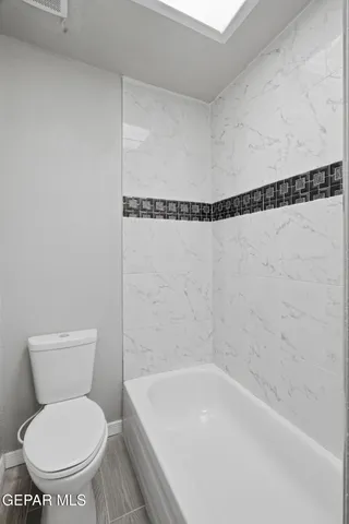 a bathroom with a shower and a bathtub