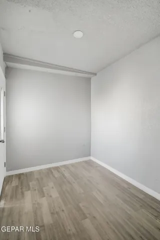 a spacious bathroom with a granite countertop sink a toilet and a mirror