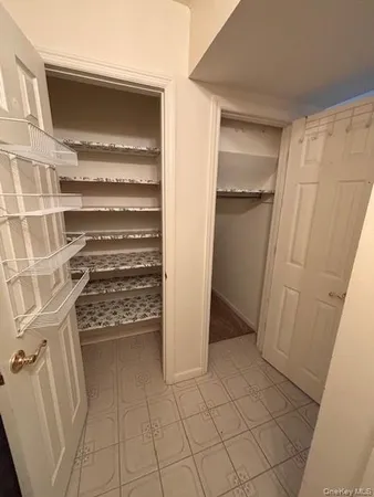 a view of walk in closet with empty racks