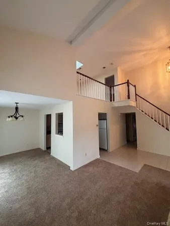 a view of a big room with closet and windows