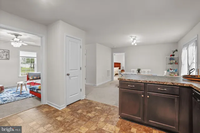 a kitchen with stainless steel appliances granite countertop a refrigerator stove and sink