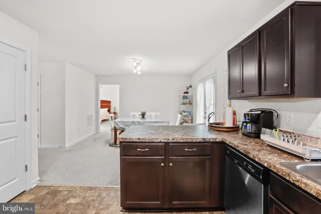 a view of kitchen with cabinets and wooden floor