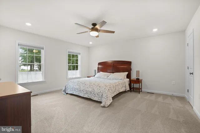 a view of kitchen with stainless steel appliances granite countertop refrigerator oven cabinets dining table and chairs