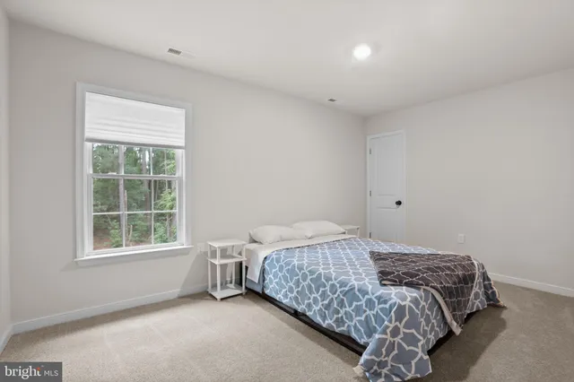 a bathroom with a granite countertop sink a toilet and a mirror