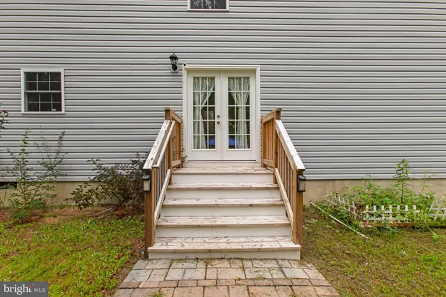 a view of a backyard with table and chairs under an umbrella