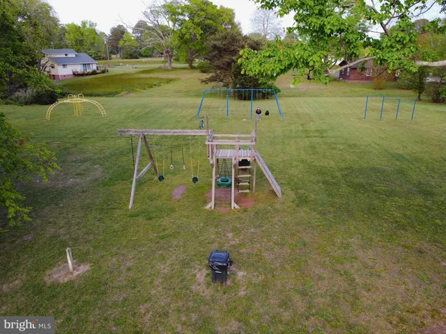an aerial view of a house with a yard and lake view