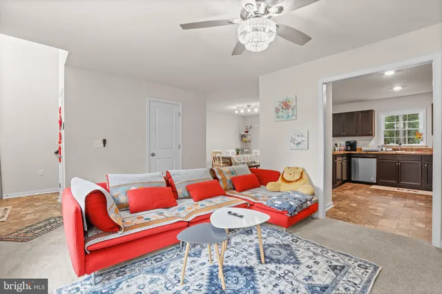 a living room with furniture a rug and a window