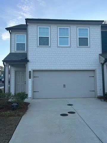 a front view of a house with garage