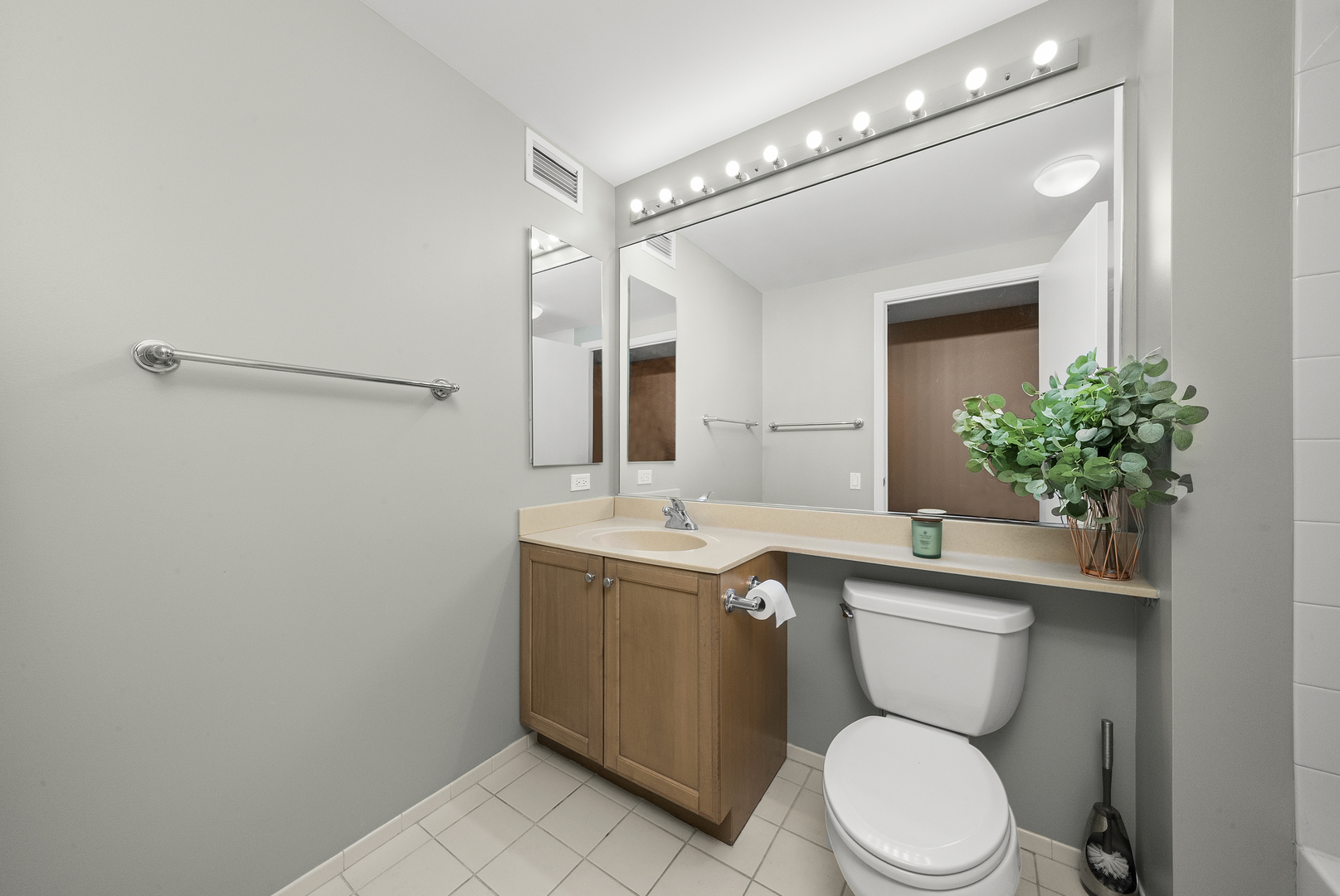 400 North LaSalle Drive, Unit 2002 Chicago, IL 60654 - Photo 13 of 30 a bathroom with a sink a toilet a mirror and shower