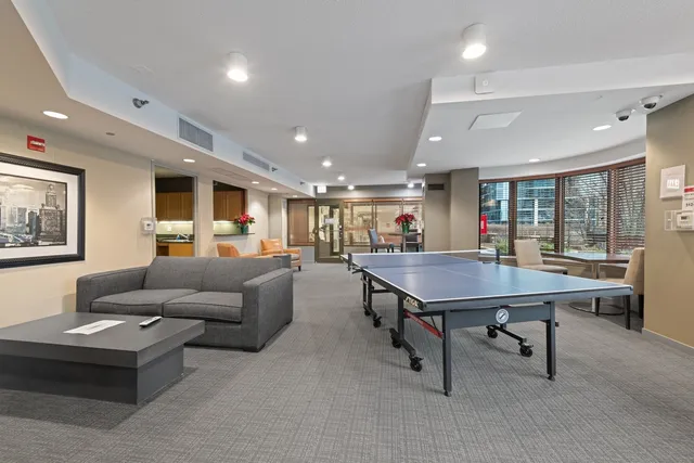 a living room with furniture a table and a large window