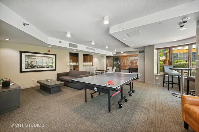 a living room with furniture a table and large window