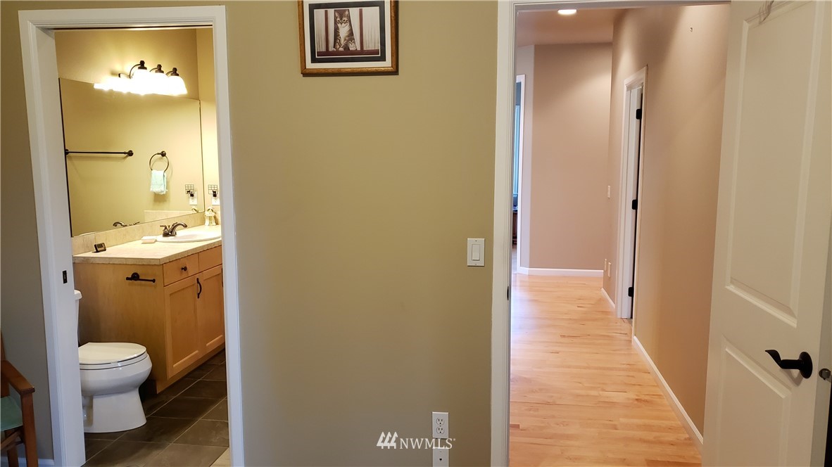 1072 Heath Road Sequim, WA 98382 - Photo 22 of 37 a bathroom with a granite countertop toilet and a shower