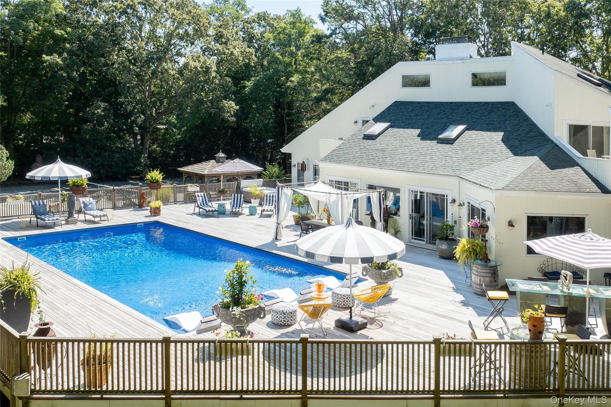 a view of a house with swimming pool and furniture