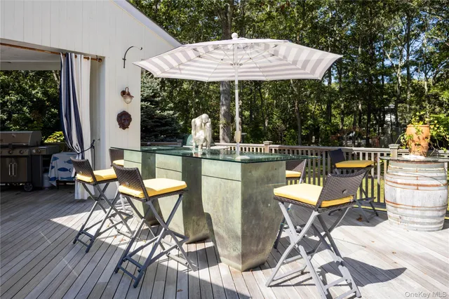 a view of a chairs and table in patio with a fire pit
