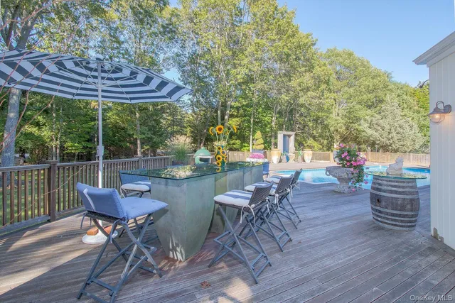 a view of a chairs and table in the patio with a fire pit