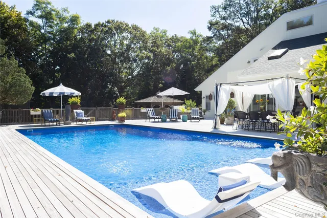 swimming pool view with a seating space