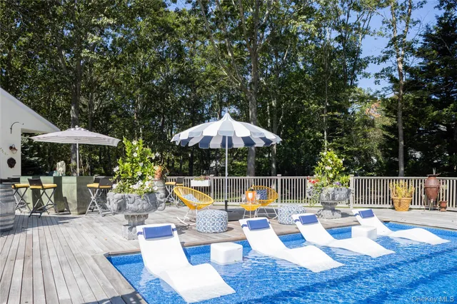 a view of swimming pool with sitting area