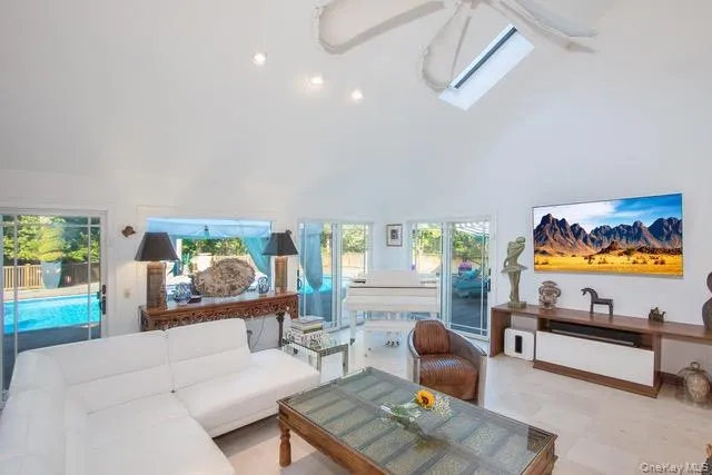a living room with furniture a rug and a flat screen tv