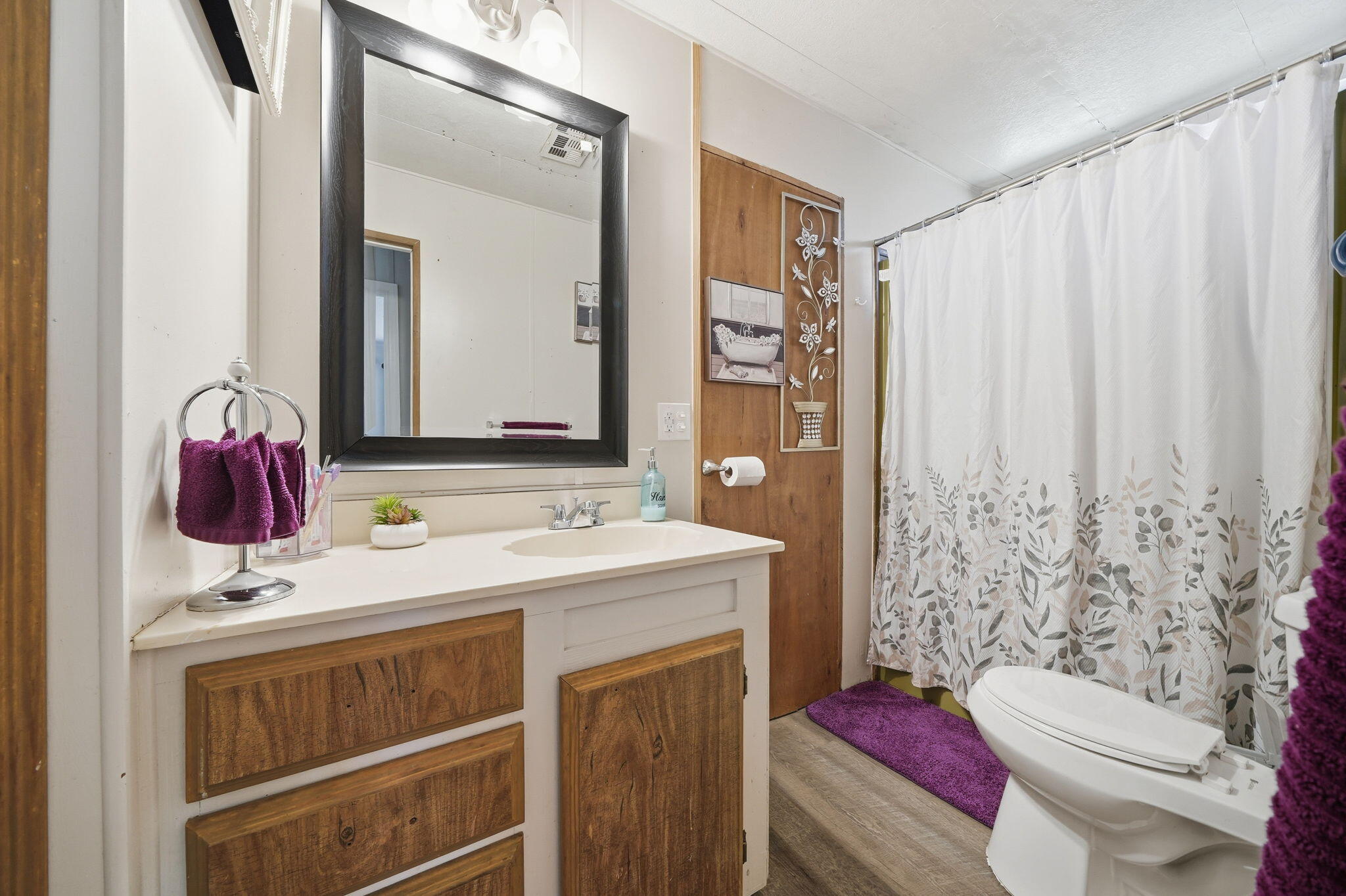 17300 Lassen Avenue Anderson, CA 96007 - Photo 18 of 34 a bathroom with a sink a toilet and shower curtain