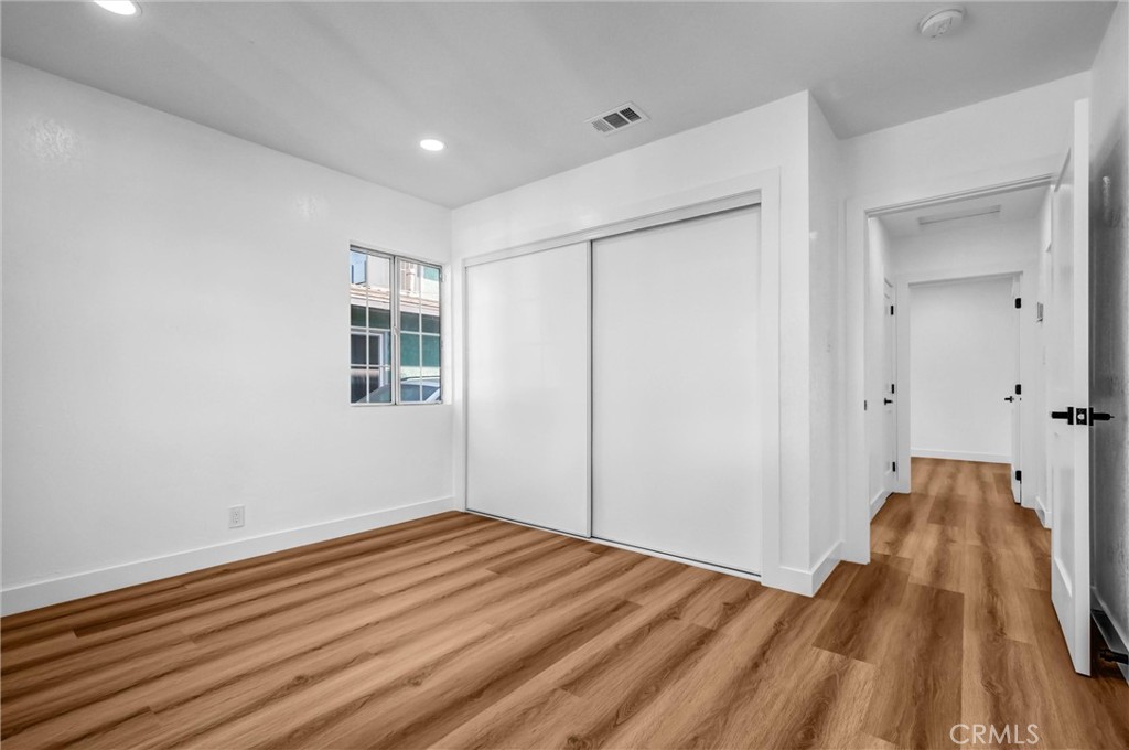 1200 South Castlegate Avenue Compton, CA 90221 - Photo 19 of 39 a view of a room with wooden floor and a bathroom