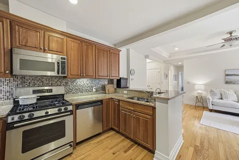 a kitchen with stainless steel appliances a stove sink and cabinets