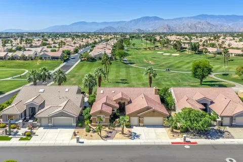 an aerial view of residential houses with outdoor space and street view
