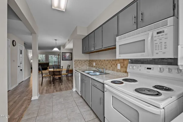 a kitchen with a stove and a refrigerator