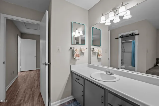 a bathroom with a shower a toilet and a sink