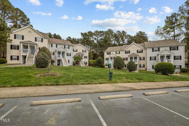 an aerial view of a house with swimming pool and patio