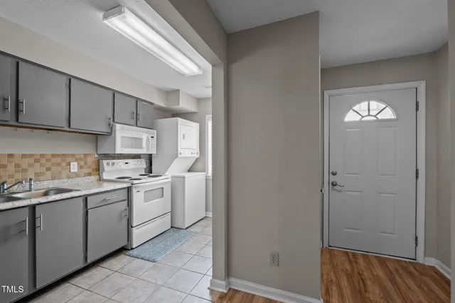 a kitchen that has a sink and a stove