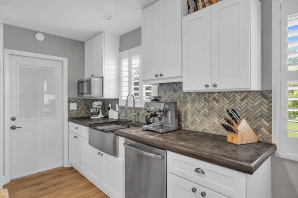 102 Pineview Road Jupiter, FL 33469 - Photo 12 of 34 a kitchen with stainless steel appliances granite countertop a sink a stove and cabinets