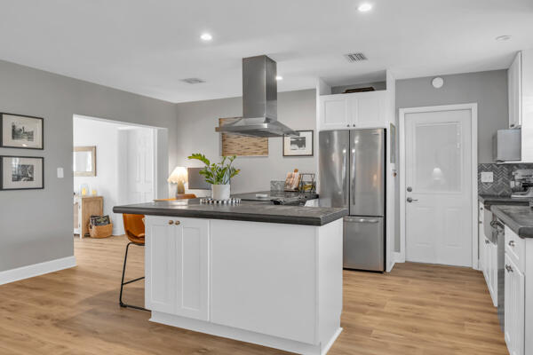 102 Pineview Road Jupiter, FL 33469 - Photo 13 of 34 a kitchen with stainless steel appliances a sink and wooden floors