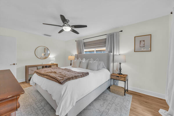 102 Pineview Road Jupiter, FL 33469 - Photo 20 of 34 a bedroom with a bed and a chandelier