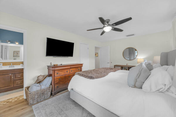 102 Pineview Road Jupiter, FL 33469 - Photo 21 of 34 a bedroom with a bed and a flat screen tv