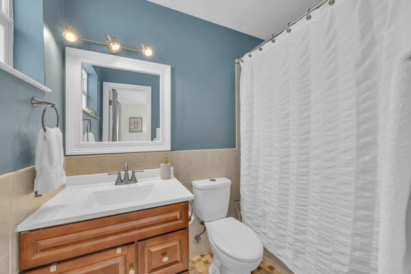 102 Pineview Road Jupiter, FL 33469 - Photo 24 of 34 a bathroom with a sink a toilet and mirror